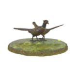 An early 20th century onyx desk stand, decorated with a brace of cold painted bronze pheasants,