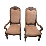 A pair of mid Victorian mahogany open arm chairs, with carved top rail, padded back and seat,