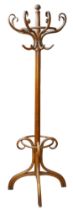 A vintage bent wood coat stand, eight branches and umbrella / stick ring, raised on four legs, 69.