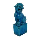 A Chinese porcelain turquoise glazed figure of a Buddhistic lion dog, circa 1960, modelled seated