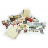 A mixed group of collectables, including military memorabilia and badges, postcards, British coins
