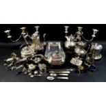 A group of silver plated wears, including a pair of candelabras, tea and coffee pots, a group of