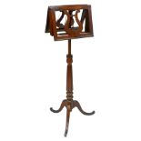 A Victorian rosewood adjustable duet music stand, raised on a reeded column and tripod base.