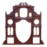 A Victorian mahogany overmantle mirror with central shield shaped bevelled glass, galleried above
