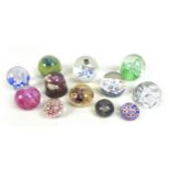 A group of nine glass paperweights, including a Langham, 8 by 8cm, a Modina, 7.5cm by 7cm, a