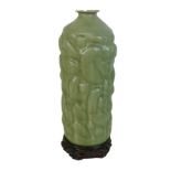 A late 20th century Thai celadon glaze vase, with organically shaped outer surface, a/f rim damaged,
