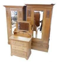 An Edwardian satin walnut bedroom suite, two single wardrobes, and dressing chest. (3)