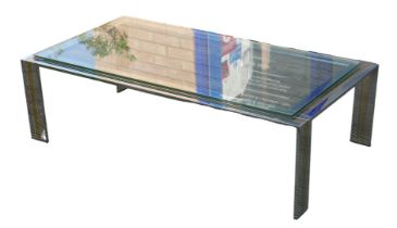 A vintage chromed metal and brass coffee table, with associated rectangular glass surface.