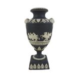 An early 19th century Adams black jasperware twin handled vase, decorated with classical scene, a/