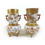 A pair of Japanese Kutani vases, of baluster form, decorated in iron red and gilt, with cartouches
