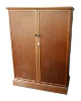 A 1950s 'Compactum' oak wardrobe, with fold out doors opening to reveal a fully fitted interior, and