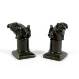 A pair of Chinese bronze desk ornaments, early 20th century, in the form of dogs seated on