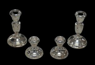 Two pairs of ERII silver candlesticks, the tallest Joseph Gloster Ltd. Birmingham 1934, with