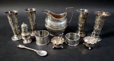A group of silver items, a group of four matching spill vases, 9.5cm high, salts, napkin rings and a