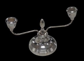 An ERII silver twin-branch candelabrum, with artichoke finial to its centre, raised upon a