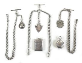 A group of three Victorian silver albert fob chains with pendants and T bars, one with gold shield