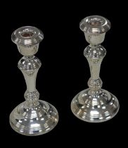 A pair of ERII silver candlesticks, with knopped stems and circular bases, W I Broadway & Co.
