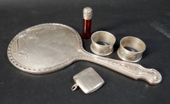 A small group of silver items, comprising two napkin rings, a vesta case, and a silver topped cut