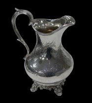 A Victorian silver milk jug, with back scroll handle, engraved floral spray decoration to its main