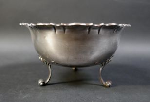 An Edward VII silver bowl, with pie crust rim, raised on three scroll feet, William Hutton & Sons,