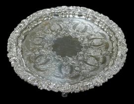 An Edwardian silver salver, with embossed scroll and foliate rim, engraved blank cartouche to its