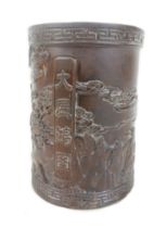 A Chinese carved wooden brushpot depicting an Eagle in flight 11cm diameter by 15cm tall