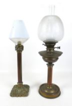 A Harrods Store oil lamp with a chimney and shade 86cm tall and a brass and copper candlestick
