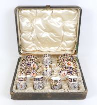 An Edwardian Royal Crown Derby Imari pattern coffee set, 2451, six settings, with Rococo style