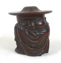 An Oriental carved wooden lidded figure of a sleeping man, signed to base and top, 15cm wide by 16cm