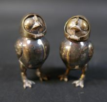 A pair of silver plated pepperettes, early to mid 20th century, in the form of chicks with fold over
