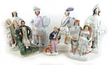 An interesting collection of seven Staffordshire figures including Rob Roy and Wallace, tallest 45