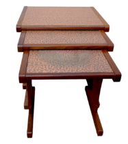 A nest of three G-Plan side tables with textured copper tops, largest 52 by 4.5 by 48cm high. (3)