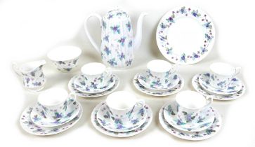 A modern hand painted bone china tea set, decorated with purple flowers and leaves, each signed '