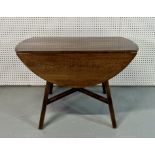 ERCOL; A MID 20TH CENTURY CIRCULAR DROP FLAP DINING TABLE