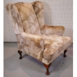 A MODERN WINGBACK ARMCHAIR