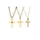 A GOLD PENDANT CROSS WITH A 9CT GOLD NECKCHAIN AND TWO FURTHER GOLD PENDANT CROSSES WITH...