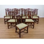 A SET OF TWELVE GEORGE III STYLE MAHOGANY FRAMED PIERCED SPLAT BACK DINING CHAIRS (12)