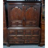 A 17TH CENTURY OAK RAISED PANELLED TWO DOOR LIVERY CUPBOARD