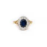 AN 18CT GOLD, SAPPHIRE AND DIAMOND OVAL CLUSTER RING