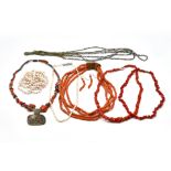 A FOUR ROW NECKLACE OF CORAL BEADS, A SINGLE ROW NECKLACE OF PALE CORAL BEADS AND SIX FURTHER...