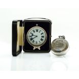 A VICTORIAN SILVER MOUNTED BEDSIDE CLOCK AND A PAPERWEIGHT DESK CLOCK (2)