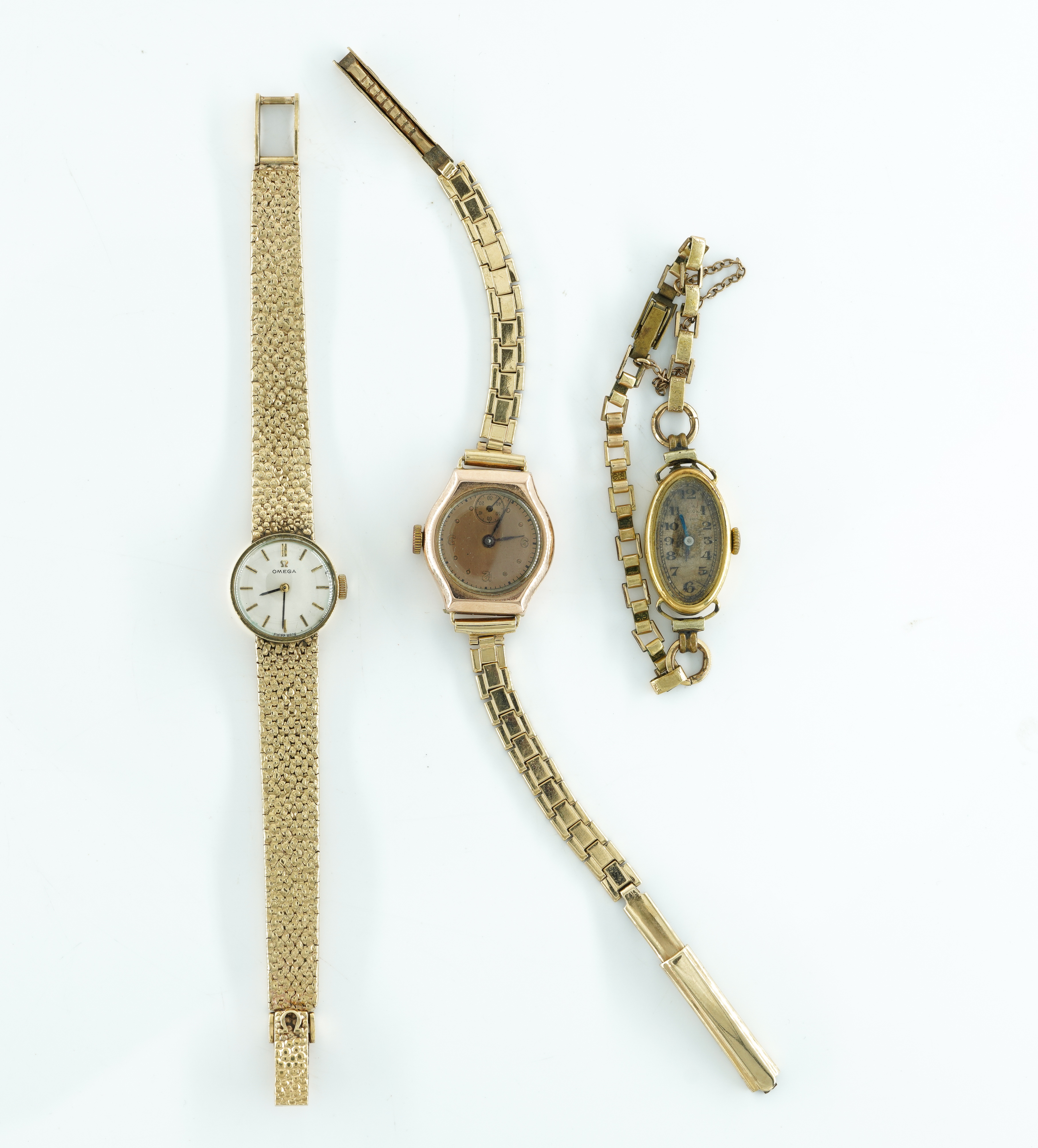 OMEGA. A LADIES 9CT GOLD MANUAL WIND BRACELET WRISTWATCH AND TWO FURTHER GOLD LADIES WATCHES (3)