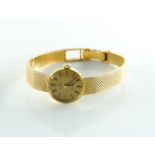 OMEGA: A LADIES 18K GOLD CASED MANUAL WIND WRISTWATCH