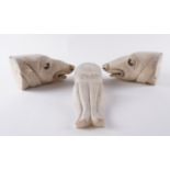A PAIR OF CARVED STONE MEDIEVAL STYLE DOG HEAD FINIALS OR BOOKENDS AND A CARVED MARBLE OCTOPUS...