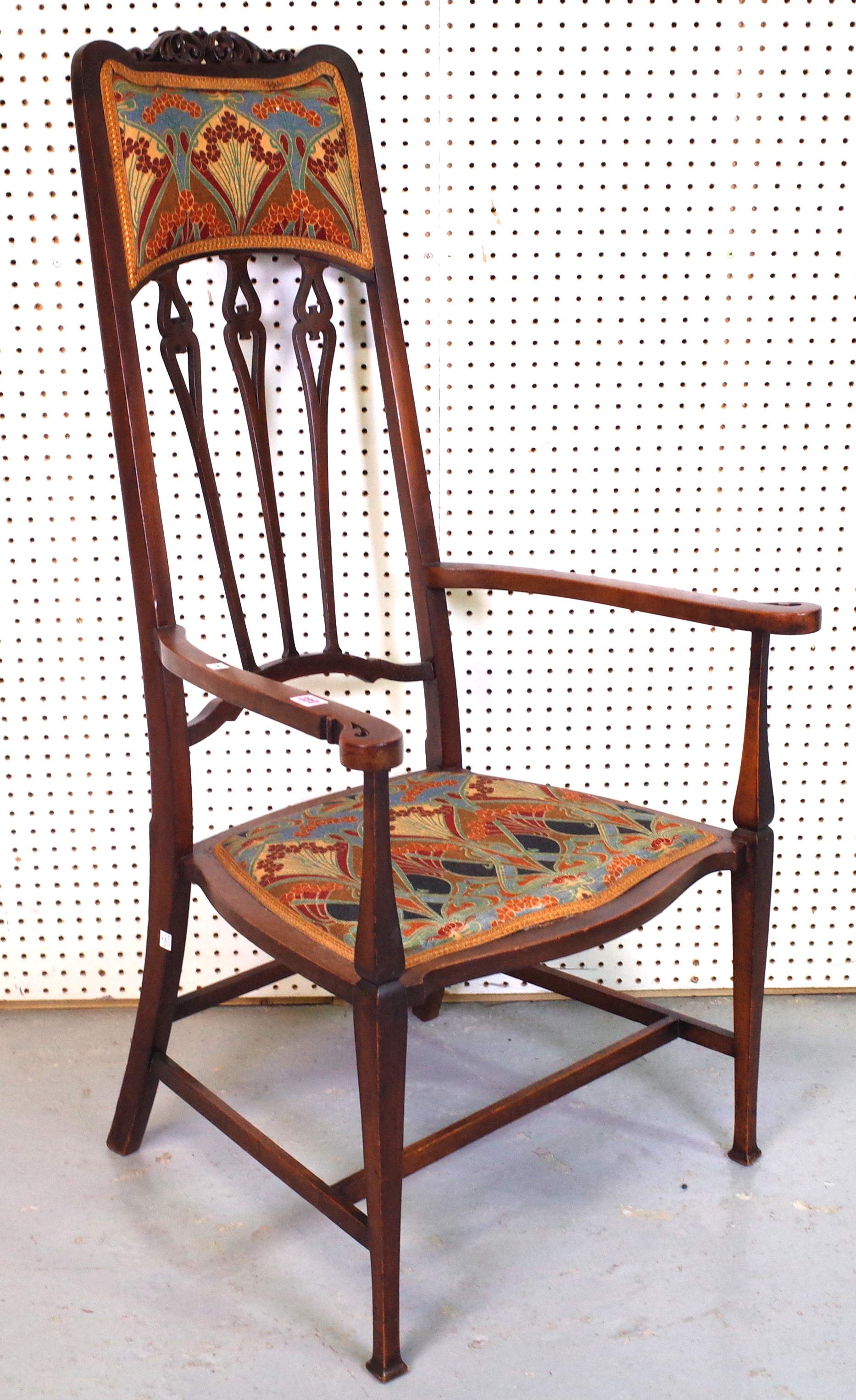 AN EARLY 20TH CENTURY LIBERTY’S STYLE HIGHBACK ARMCHAIR