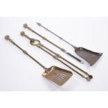 A GEORGE III STEEL SHOVEL TOGETHER WITH A SET OF THREE BRASS FIRE TOOLS (4)