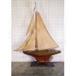 AN EARLY 20TH CENTURY PAINTED MODEL OF A POND YACHT