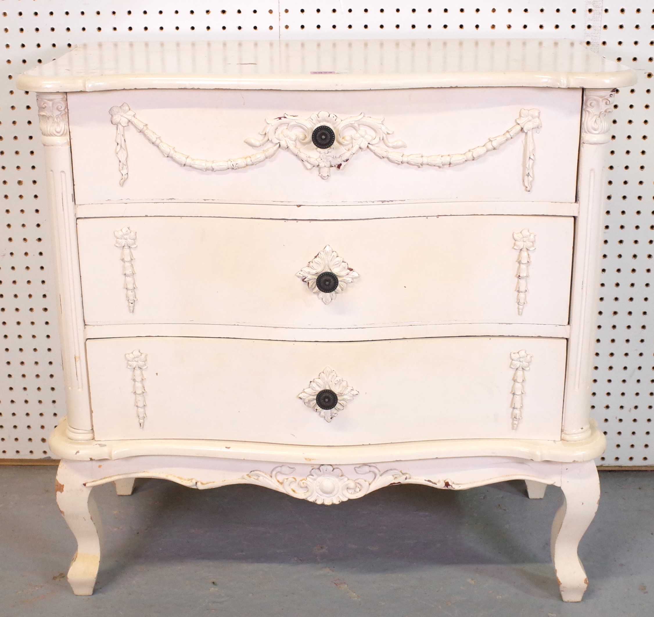 A NEOCLASSICAL REVIVAL WHITE PAINTED SERPENTINE THREE DRAWER CHEST