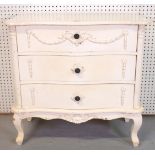 A NEOCLASSICAL REVIVAL WHITE PAINTED SERPENTINE THREE DRAWER CHEST