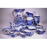 A LARGE QUANTITY OF 19TH CENTURY AND LATER BLUE AND WHITE JUGS AND GRAVY BOATS (QTY)